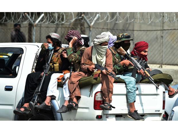 Taliban fighters guard outside the airport in Kabul on Aug. 31.