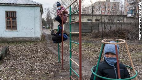 Ученики школы № 5 играют на детской площадке в ожидании автобуса после школы 8 декабря 2021 года в Красногоровке, Украина. 