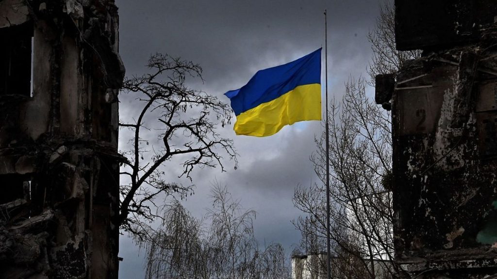 The Ukrainian flag flutters between buildings destroyed in bombardment, in the Ukrainian town of Borodianka, in the Kyiv region